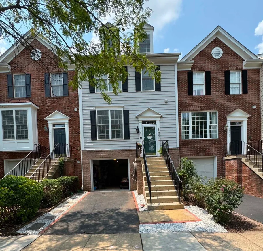 A townhouse entry with weeded gravel beds and a clean edge cut along the driveway and walkway.